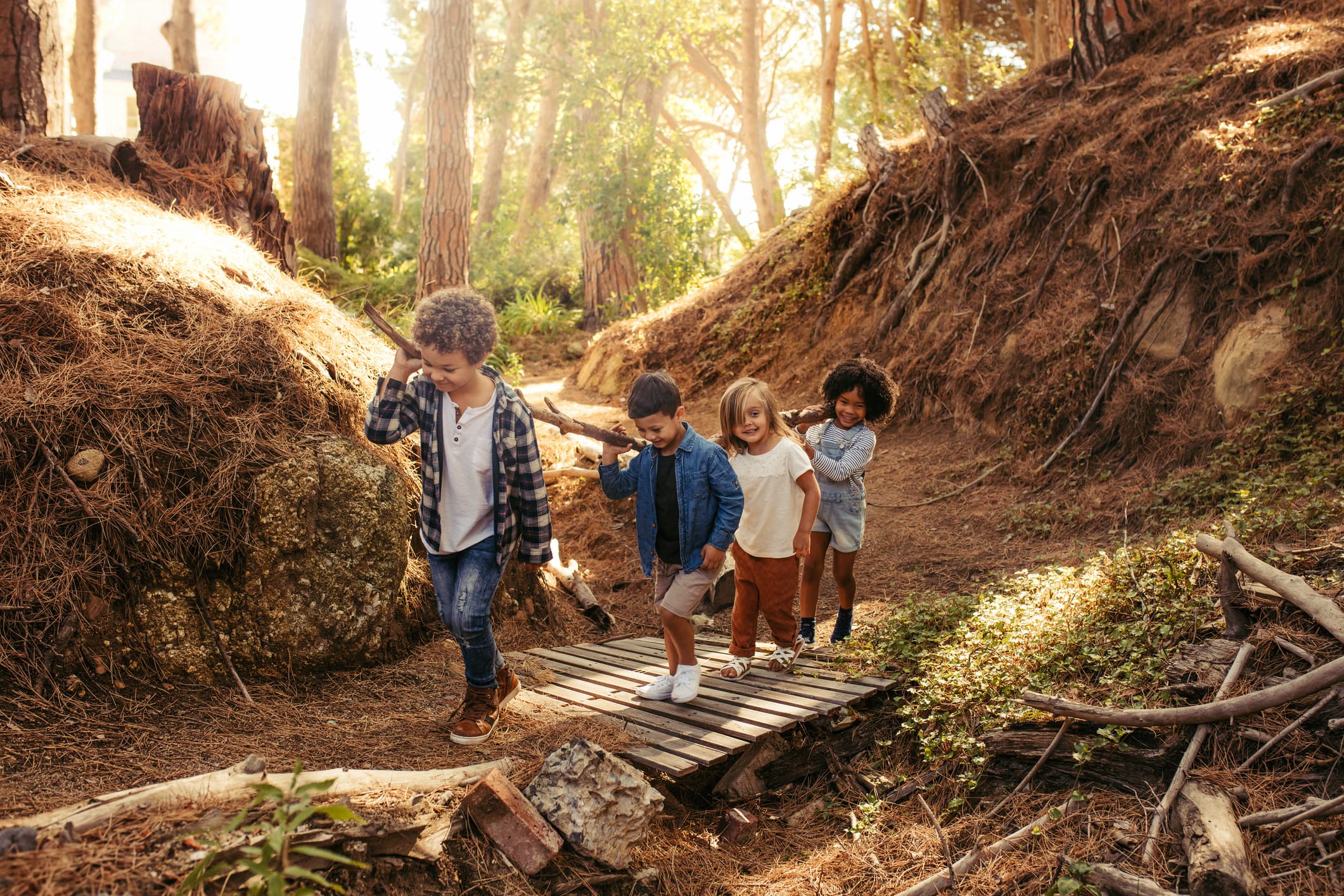 Family with young children hiking through a lush green forest